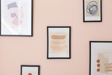 Beautiful pictures hanging on color wall, closeup