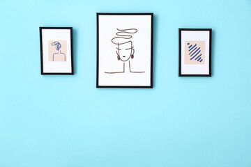 Beautiful pictures hanging on color wall