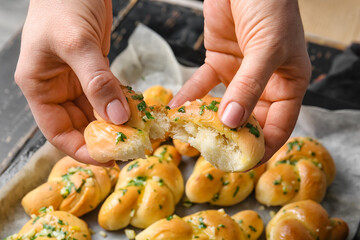 Female hands with tasty garlic buns, closeup