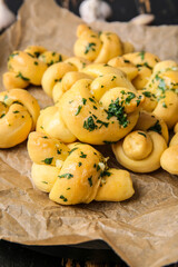 Parchment with tasty garlic buns, closeup