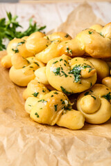 Parchment with tasty garlic buns, closeup