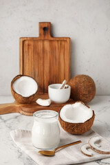 Fototapeta na wymiar Jar of tasty coconut yogurt on table