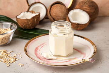 Jar of tasty coconut yogurt on table, closeup