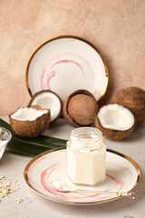 Jar with tasty coconut yogurt on table