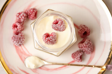 Obraz na płótnie Canvas Tasty coconut yogurt with raspberry, closeup