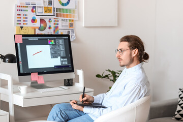 Young male designer working in office