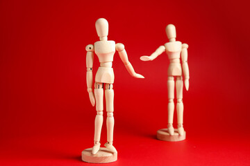 Wooden mannequins on color background