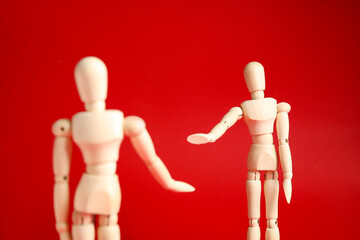 Wooden mannequins on color background