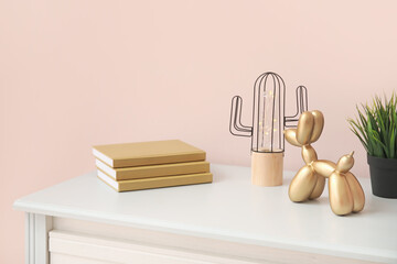 Stylish decor on table near color wall