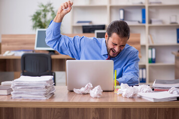 Young male employee in brainstorming concept