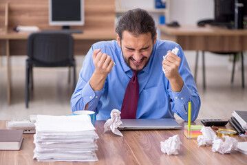 Young male employee in brainstorming concept