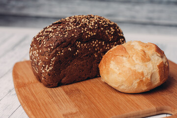 loaf of bread on a wooden board powerful products food