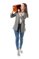 Naklejka premium Young woman with retro radio receiver on white background
