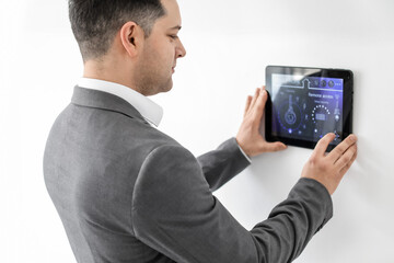 Man using smart home security system control panel