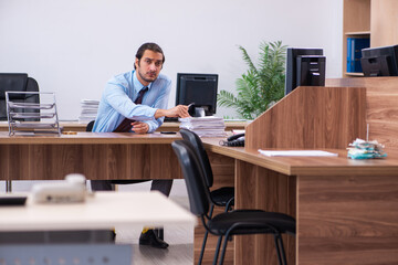 Young male employee working in the office