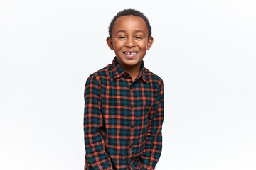 Joy, happiness and positive emotions. Horizontal shot of carefree adorable schoolboy posing isolated with happy facial expression, excited because of excellent marks, having fun, smiling broadly