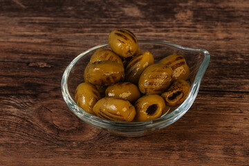Green grilled olives in the bowl