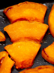 Pieces of pumpkin baked on a baking sheet. Food
