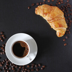 Cup of coffee and croissant