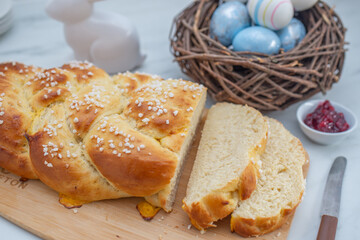 Sweet home made braided yeast bun for easter on a table