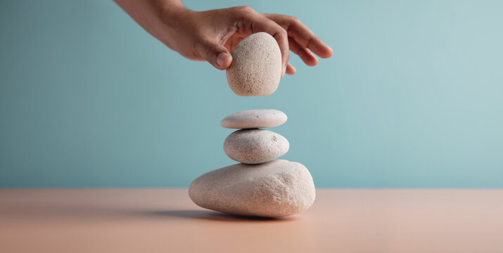Life Balance Concept. Hand Setting White Natural Zen Stone Stack. Balancing Mind, Soul and Spirit. Mental Meditation Practice