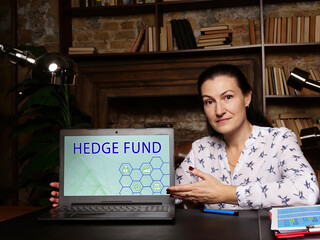 Fototapeta premium Financial concept about HEDGE FUND with sign on the laptop. A pooled investment fund that trades in relatively liquid assets and is able to make extensive use of more complex trading