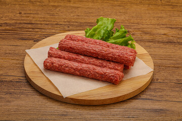 Raw beef sausages with spices