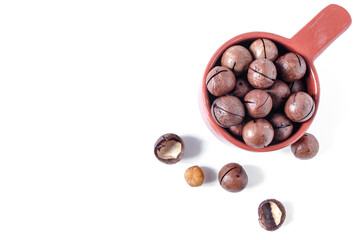 sweet macadamia nut in a colored dish on a light background macadamia nut in a shell