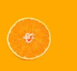 orange slice lies on a colored background