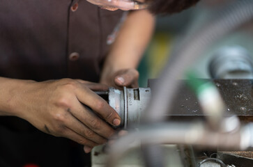 worker turn Crossfeed handwheel on a lathe machine cross slide
