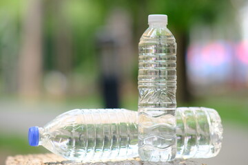 bottle of water in green natural background and space