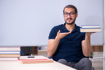 Young male handicapped student in the classroom