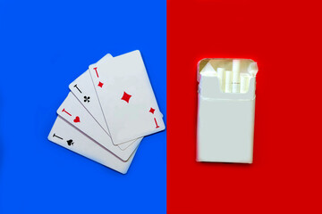 Cigarettes and cards. Cigarettes on a red background and cards on a blue background.