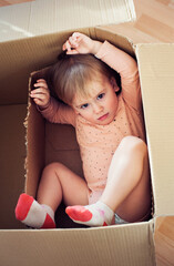 Baby toddler in a carton box