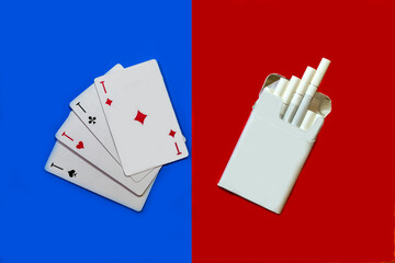 Cigarettes and cards. Cigarettes on a red background and cards on a blue background.