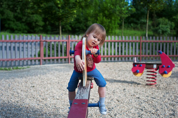 Little girl playing on a teeter