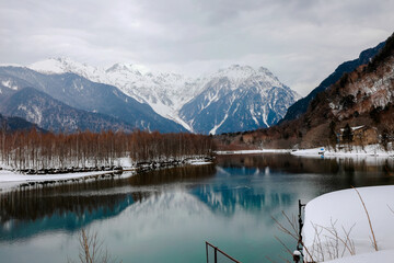 Landscape of snow mountain with rivers at the Kamikochi in Japan Alps Mountain. Winter season concept.