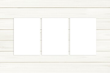 Three posters, white writing paper sheets, stationery mockup, cards mock up, white wooden background, 