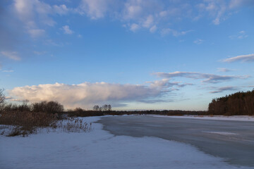 Spring landscape with a river. ice melts on the river. Evening.