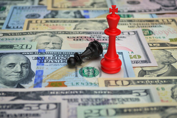 Red chess king wins the game vs black pawn with calculator and pencil on dollar bank note money,...