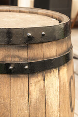 Fototapeta premium light beige oak barrel with a hoop close-up vertically close-up