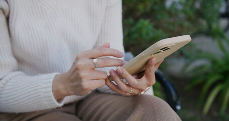 Woman use of mobile phone and sit at park
