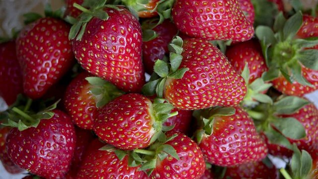 Strawberries is a stock video that contains fine footage of fresh strawberries rotating. This 3840x2160 (4K) bit of footage will look beautiful in any video project that depicts fruits, food, diet, et