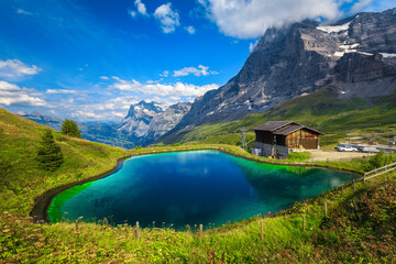 Alpine turquoise lake and Eiger mountain in background, Switzerland - 423489562