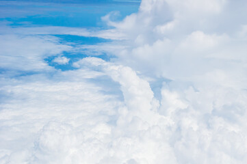 over the clouds,Blue sky with tiny clouds background Beautiful natural view from airplane window above. Background or Wallpaper.blue sky and cloud sky nature.Top view of aircraft