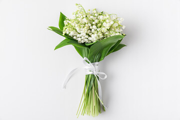Spring lily of the valley flowers bouquet on white background. Flat lay. Top view. wedding concept