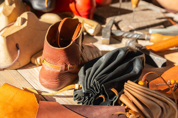 handmade leather boot, wooden block and pouch purse leather goods