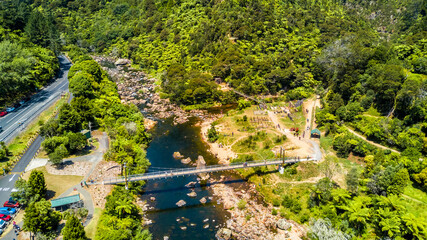 Cable bridge across mountain river. Coromandel, New Zealand.