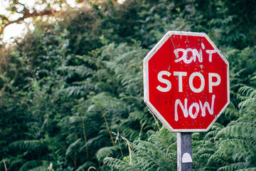 Message don't stop know painted on street sign