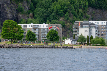 Holmestrand, Norway - June 13 th 2020. A paraglider landing near the beach in Holmestrand.